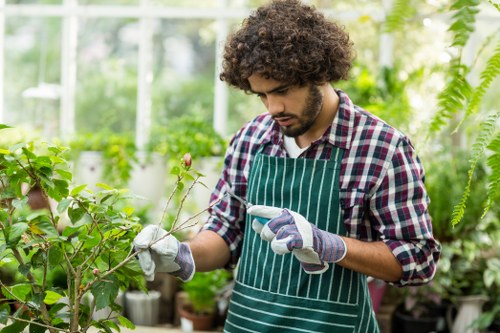 Gardener preparing to trim a hedge in Notting Hill with safety gear